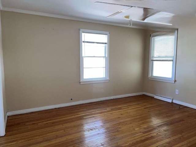unfurnished room with ornamental molding, hardwood / wood-style floors, and a healthy amount of sunlight