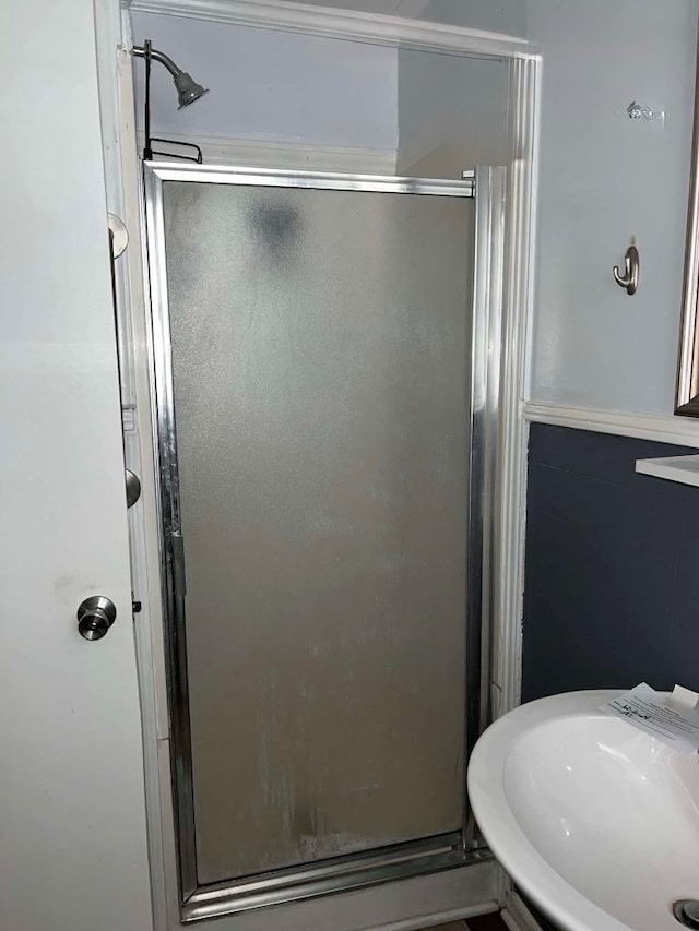 bathroom featuring a sink and a stall shower