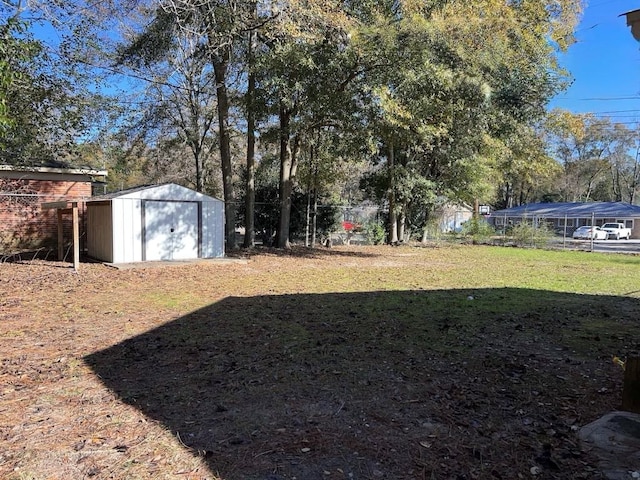 view of yard with an outdoor structure and a storage shed