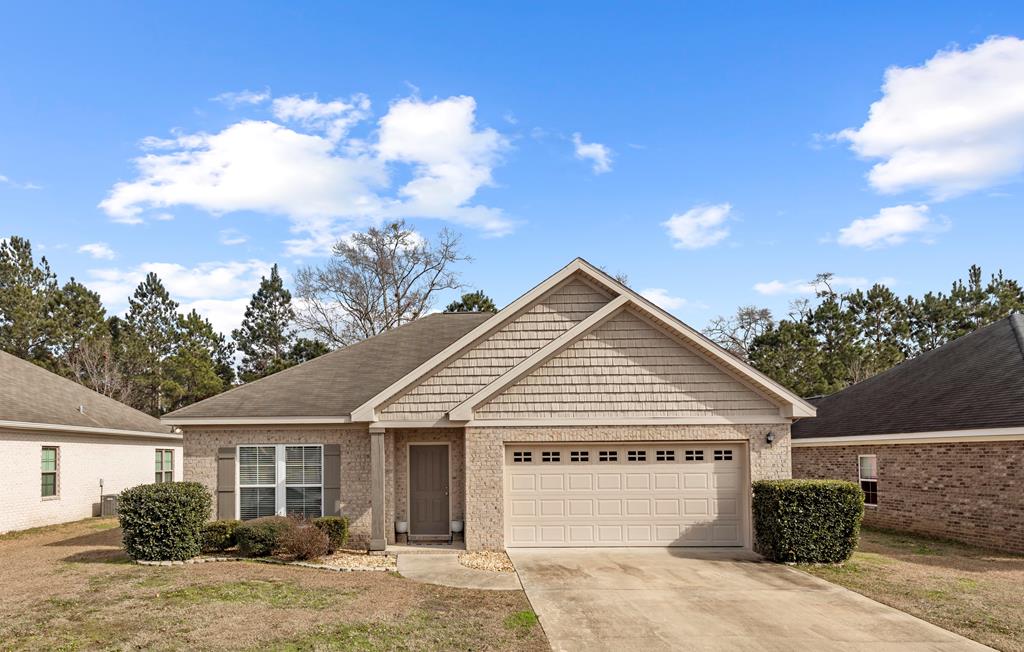 view of front of house featuring a garage and a front lawn