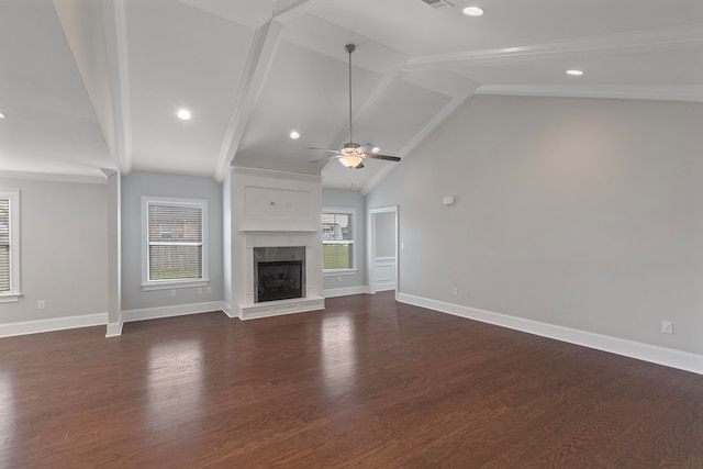 unfurnished living room with a high end fireplace, lofted ceiling with beams, dark hardwood / wood-style floors, and ceiling fan