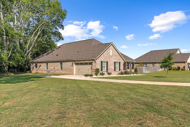 view of front facade with a garage and a front lawn