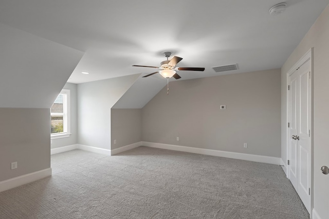 bonus room with ceiling fan, light colored carpet, and vaulted ceiling