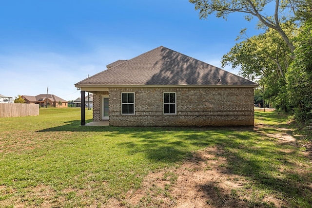 rear view of property with a lawn