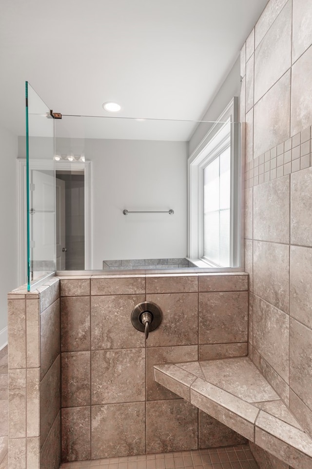 bathroom featuring tile patterned floors and tiled shower