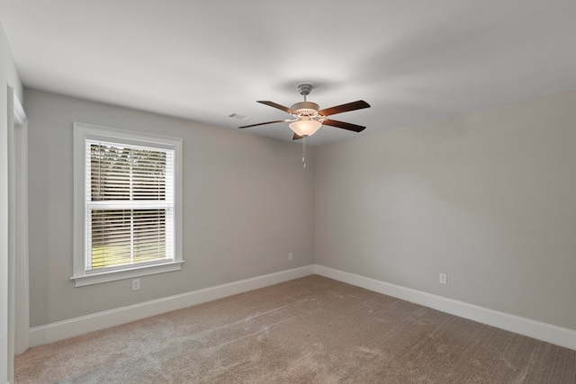 unfurnished room with ceiling fan and light colored carpet