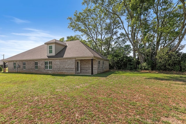 back of house with a lawn