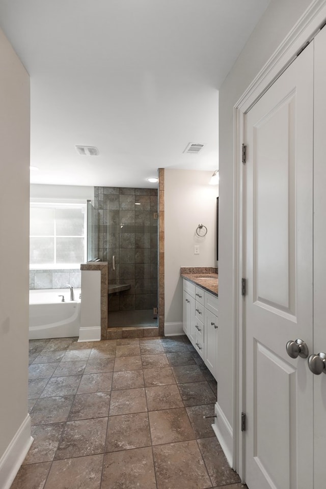 bathroom featuring vanity and independent shower and bath