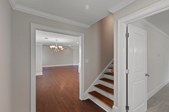 stairway featuring a notable chandelier, wood-type flooring, and crown molding