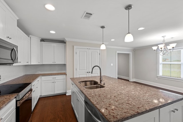 kitchen featuring sink, white cabinetry, stainless steel appliances, and a kitchen island with sink