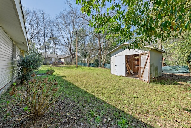 view of yard with an outbuilding and a shed