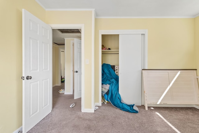 unfurnished bedroom with carpet, visible vents, and ornamental molding