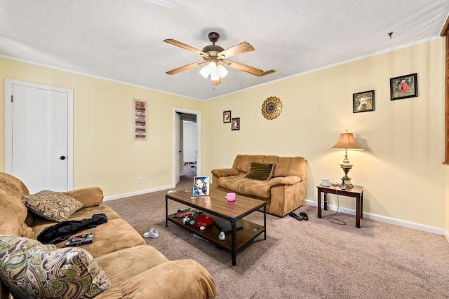 living room with carpet, ornamental molding, a ceiling fan, a textured ceiling, and baseboards