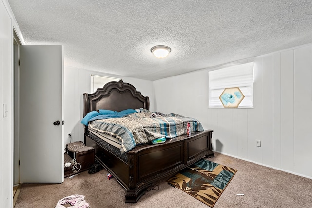 bedroom featuring carpet, multiple windows, and a textured ceiling