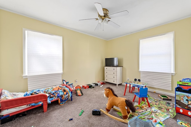 rec room featuring crown molding, ceiling fan, and carpet flooring