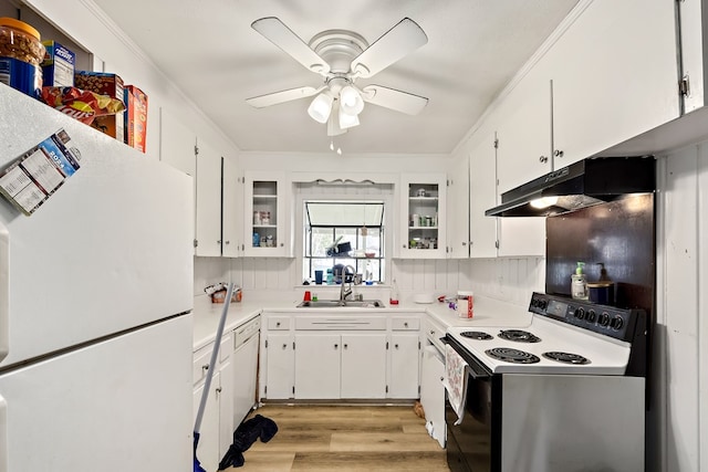 kitchen featuring electric range oven, freestanding refrigerator, white cabinetry, a sink, and under cabinet range hood