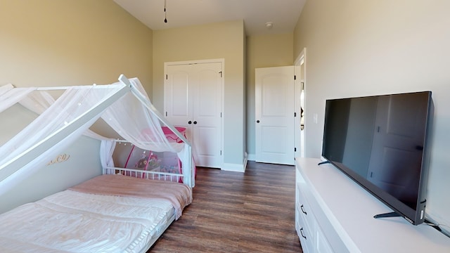 bedroom with dark wood-type flooring