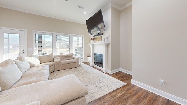 living room featuring crown molding and dark hardwood / wood-style flooring