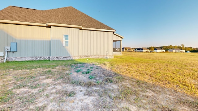 view of side of home featuring a lawn