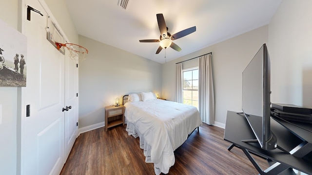 bedroom with dark hardwood / wood-style floors and ceiling fan