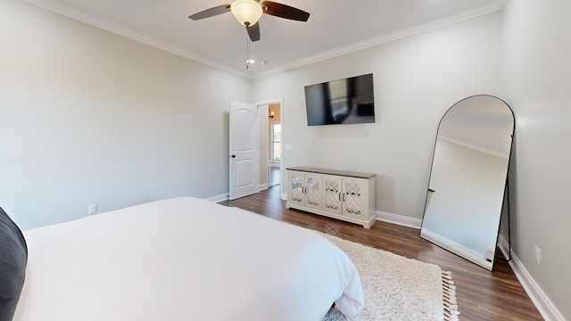 bedroom featuring crown molding, dark wood-type flooring, and ceiling fan