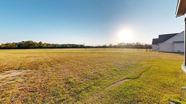 view of yard with a rural view