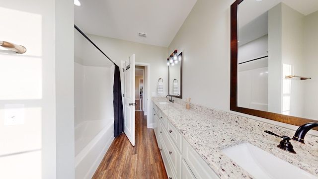 bathroom featuring vanity, hardwood / wood-style floors, and shower / bath combination