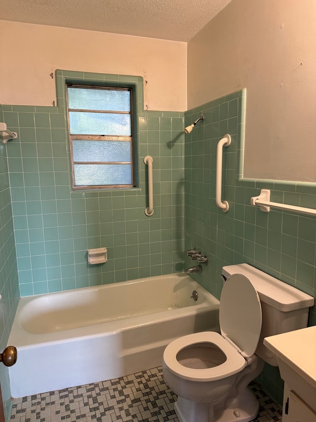530 Pleasant Grove Rd, Ashford, AL 36312 - bathroom with tile walls, vanity, wainscoting, shower / tub combination, and a textured ceiling