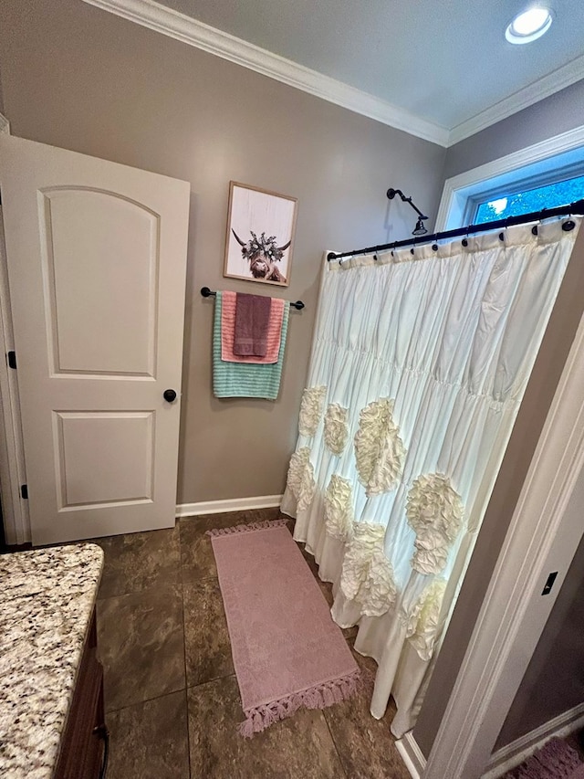 bathroom featuring tile patterned floors, crown molding, and vanity