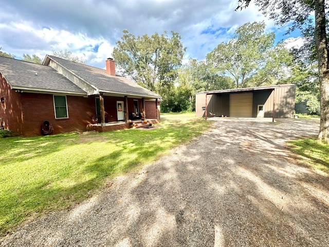 exterior space featuring an outdoor structure and a front yard