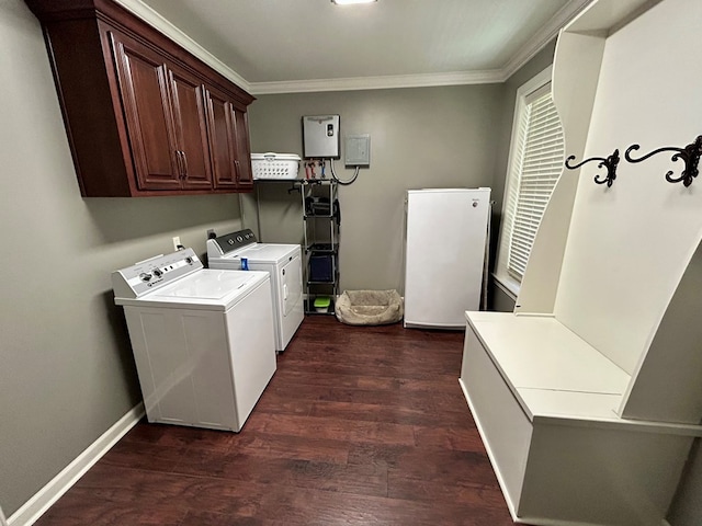 laundry area featuring separate washer and dryer, crown molding, dark wood-type flooring, and cabinets