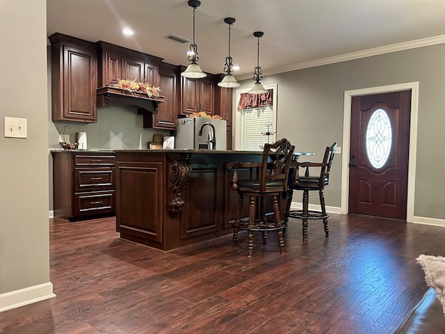 bar featuring pendant lighting, dark hardwood / wood-style floors, stainless steel fridge, ornamental molding, and dark brown cabinetry