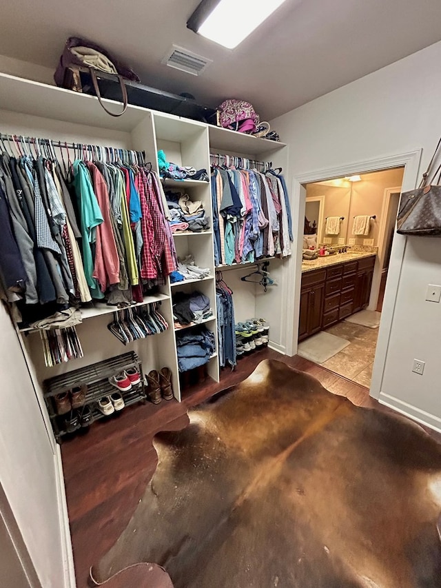 walk in closet featuring light hardwood / wood-style flooring