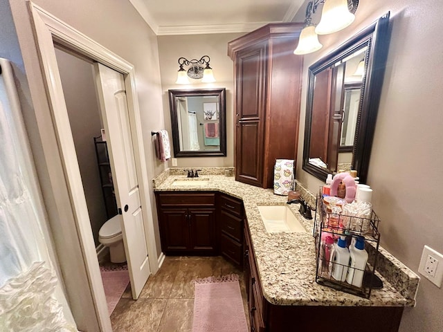 bathroom with vanity, toilet, and crown molding