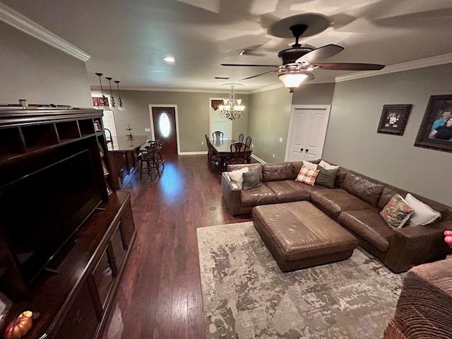 living room with crown molding, dark wood-type flooring, and a notable chandelier