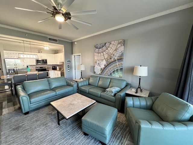living area with visible vents, ornamental molding, and ceiling fan
