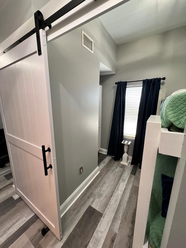 bathroom featuring visible vents, baseboards, and wood finished floors