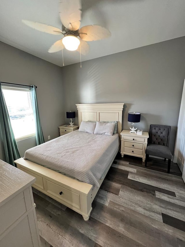 bedroom featuring ceiling fan and dark wood-type flooring
