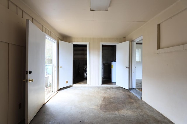 interior space with concrete flooring and water heater