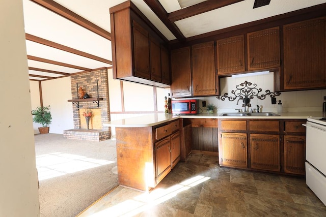 806 Mayfair St, Dothan, AL 36301 - kitchen featuring stainless steel microwave, a peninsula, light countertops, range, and dark stone finish flooring