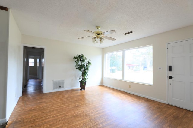 interior space featuring a textured ceiling, dark hardwood / wood-style floors, and ceiling fan