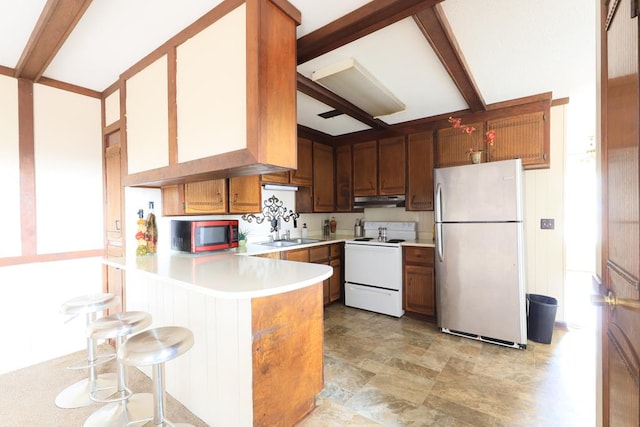 kitchen featuring white range with electric stovetop, kitchen peninsula, stainless steel fridge, and beamed ceiling