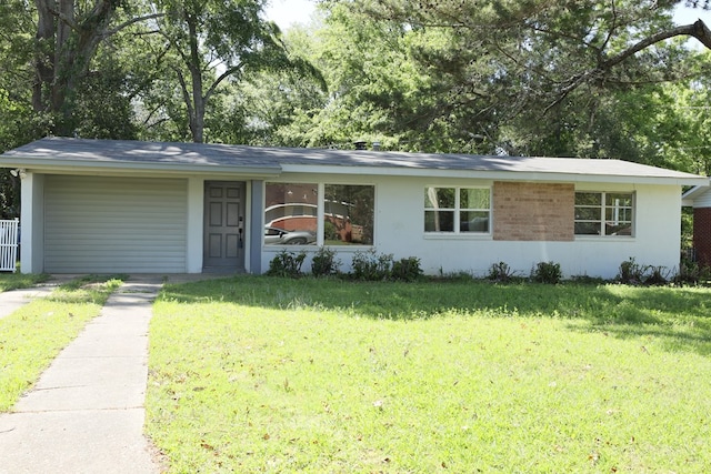 ranch-style house with a front yard, a carport, and stucco siding