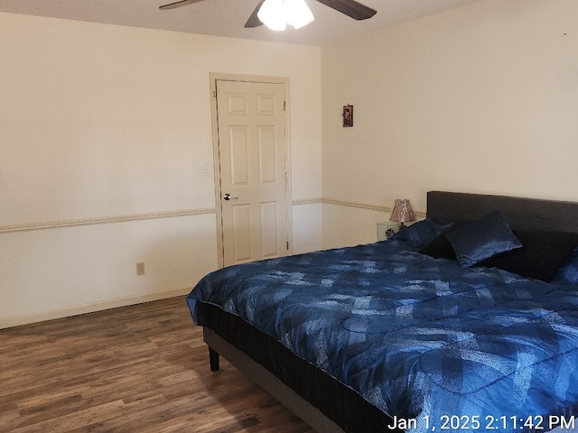 bedroom featuring ceiling fan and dark hardwood / wood-style floors