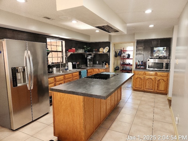 kitchen featuring a center island, sink, and stainless steel appliances