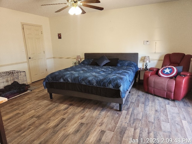 bedroom with hardwood / wood-style floors and ceiling fan