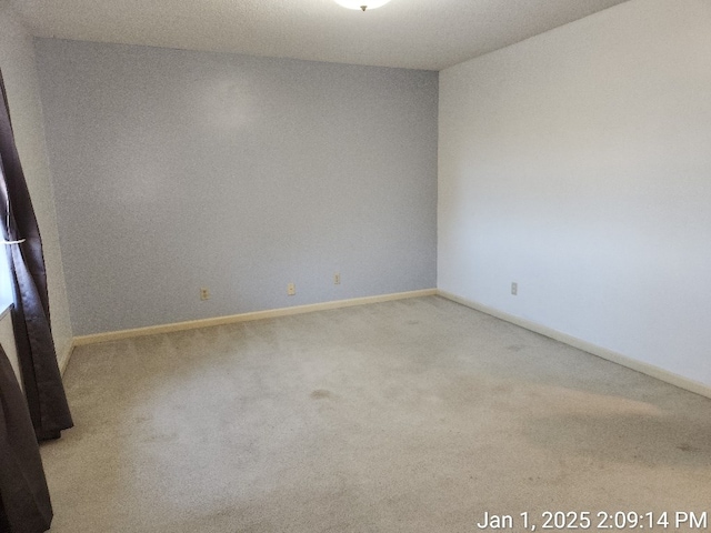 spare room with light colored carpet