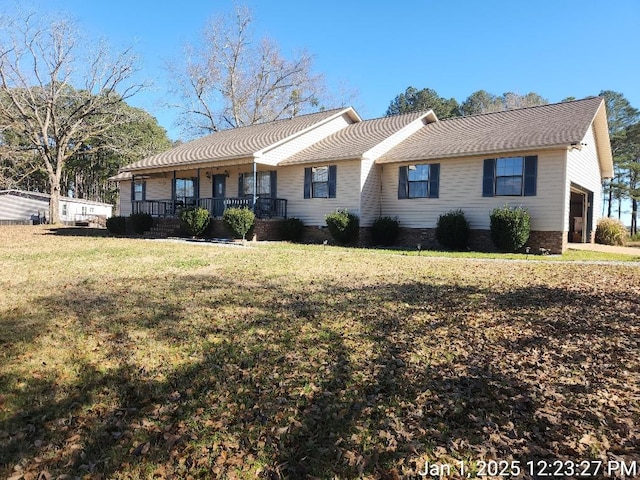 ranch-style home with covered porch, a garage, and a front lawn