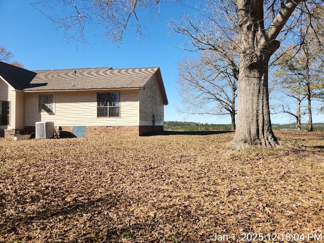 view of side of property with central AC