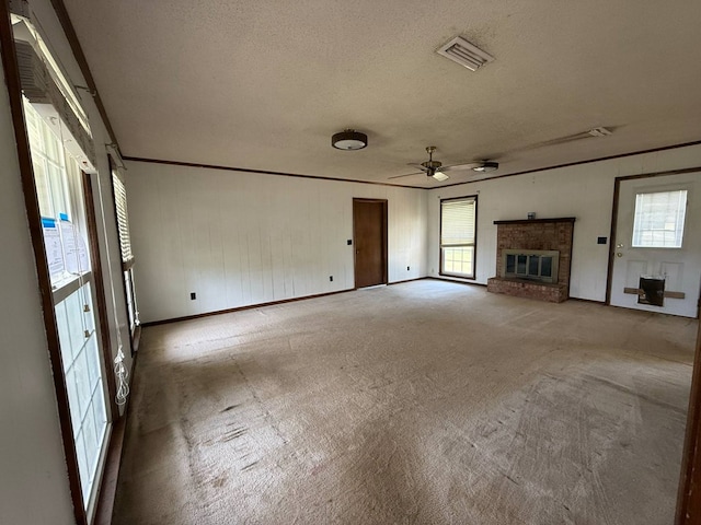 202 Candace Ct, Dothan, AL 36301 - unfurnished living room featuring carpet, healthy amount of natural light, a ceiling fan, a fireplace, and a textured ceiling